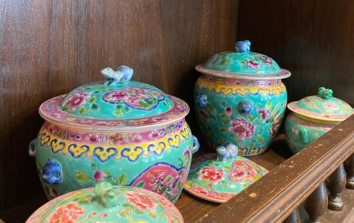 a group of colorful vases sitting on a shelf