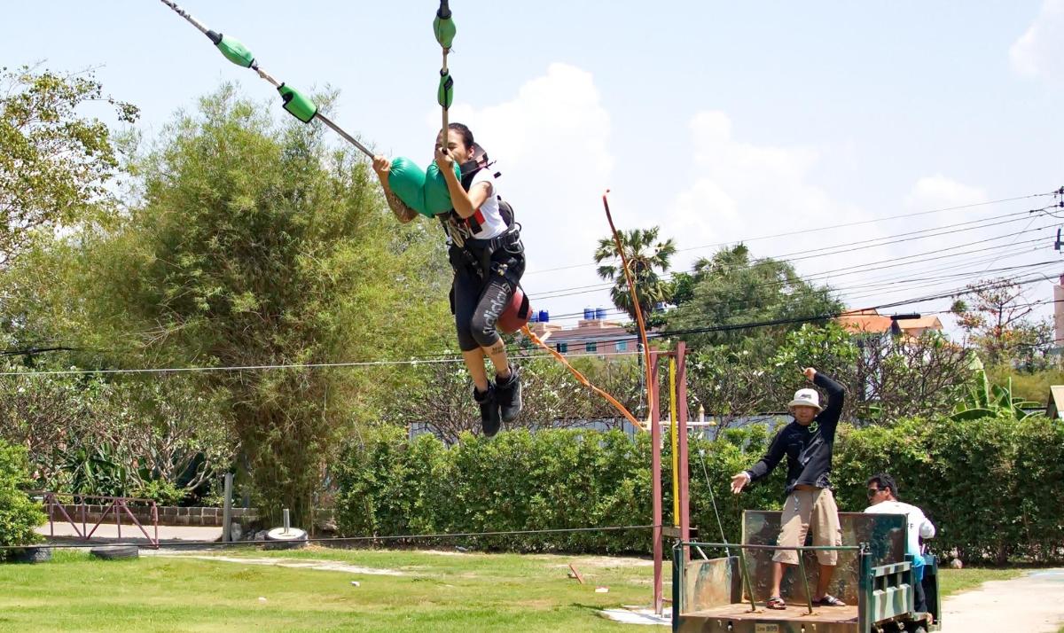 a person on a zip line in a park