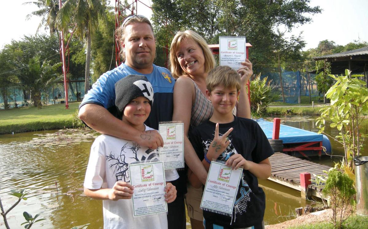 a man and two children holding up certificates