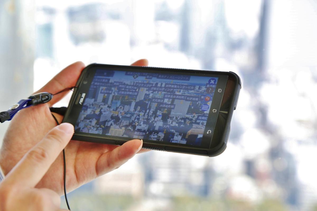 a person holding a cell phone in their hand