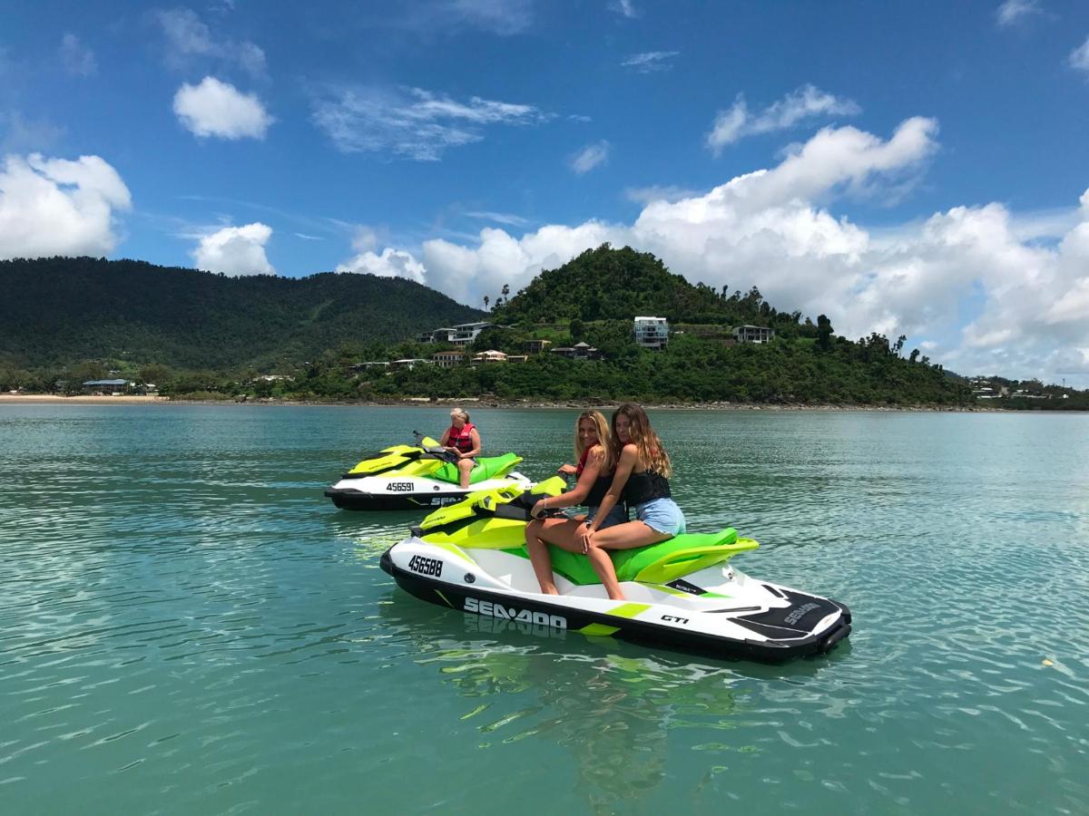 two people are riding on water peddled boats on a lake