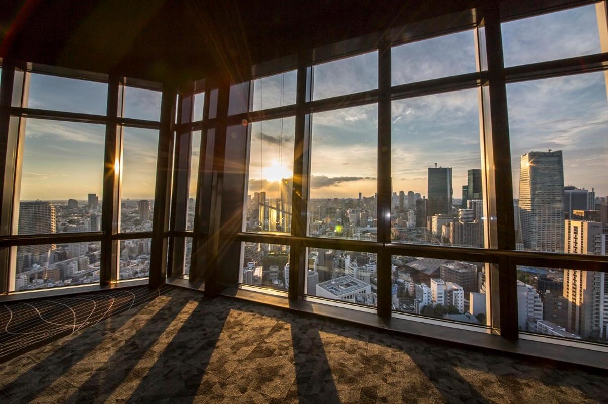 a room with large windows with a view of a city