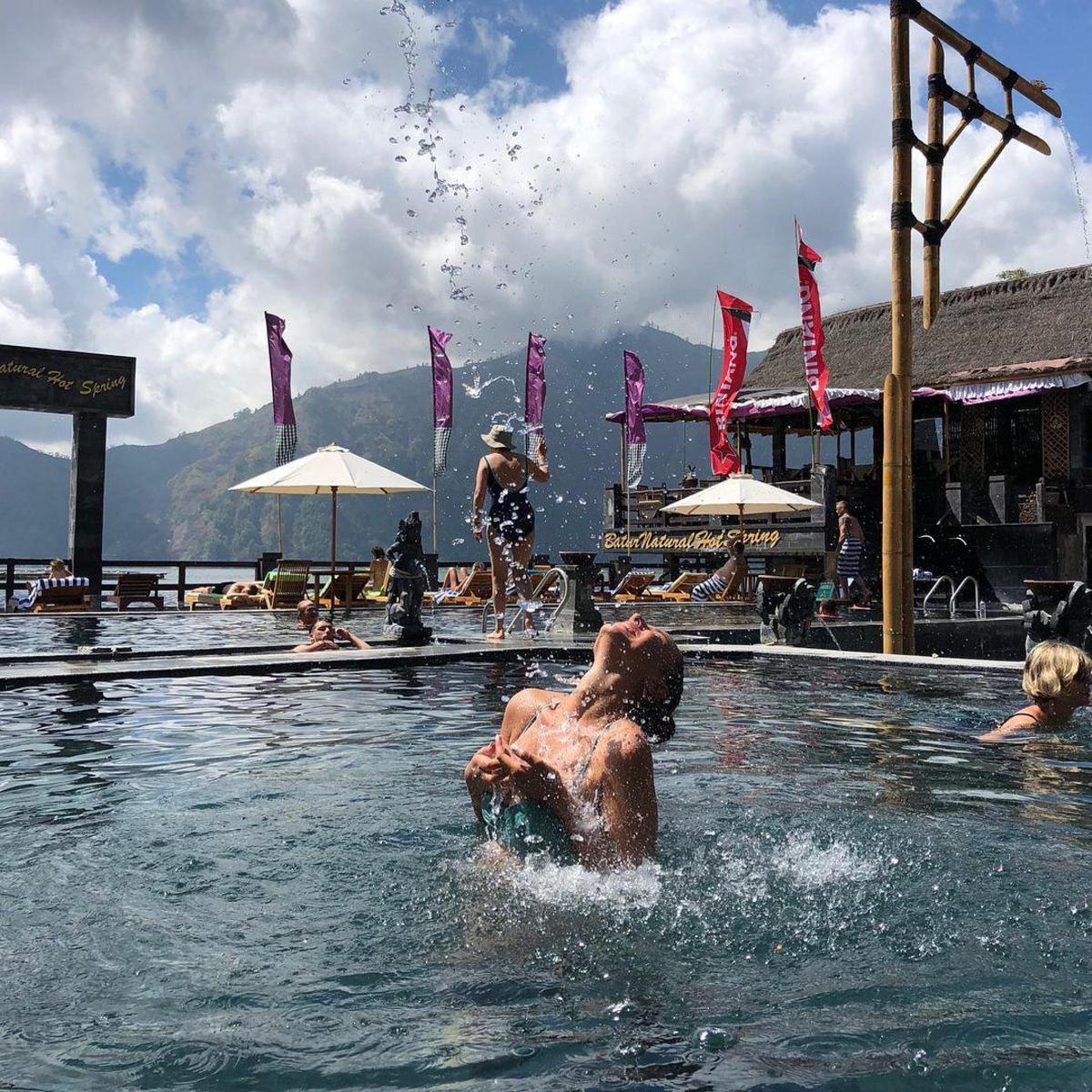 a man in the water in a swimming pool