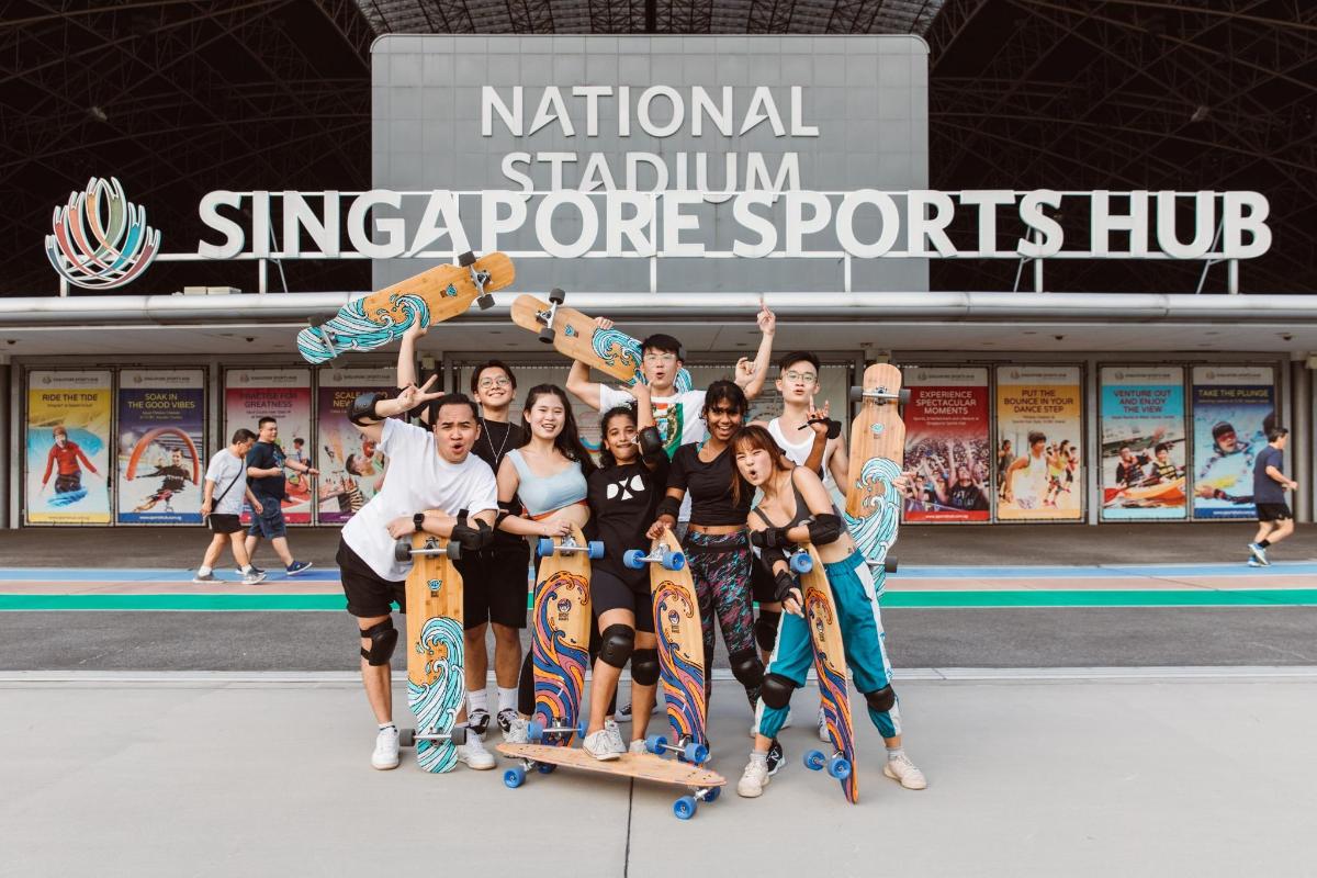 a group of people holding up their skateboards