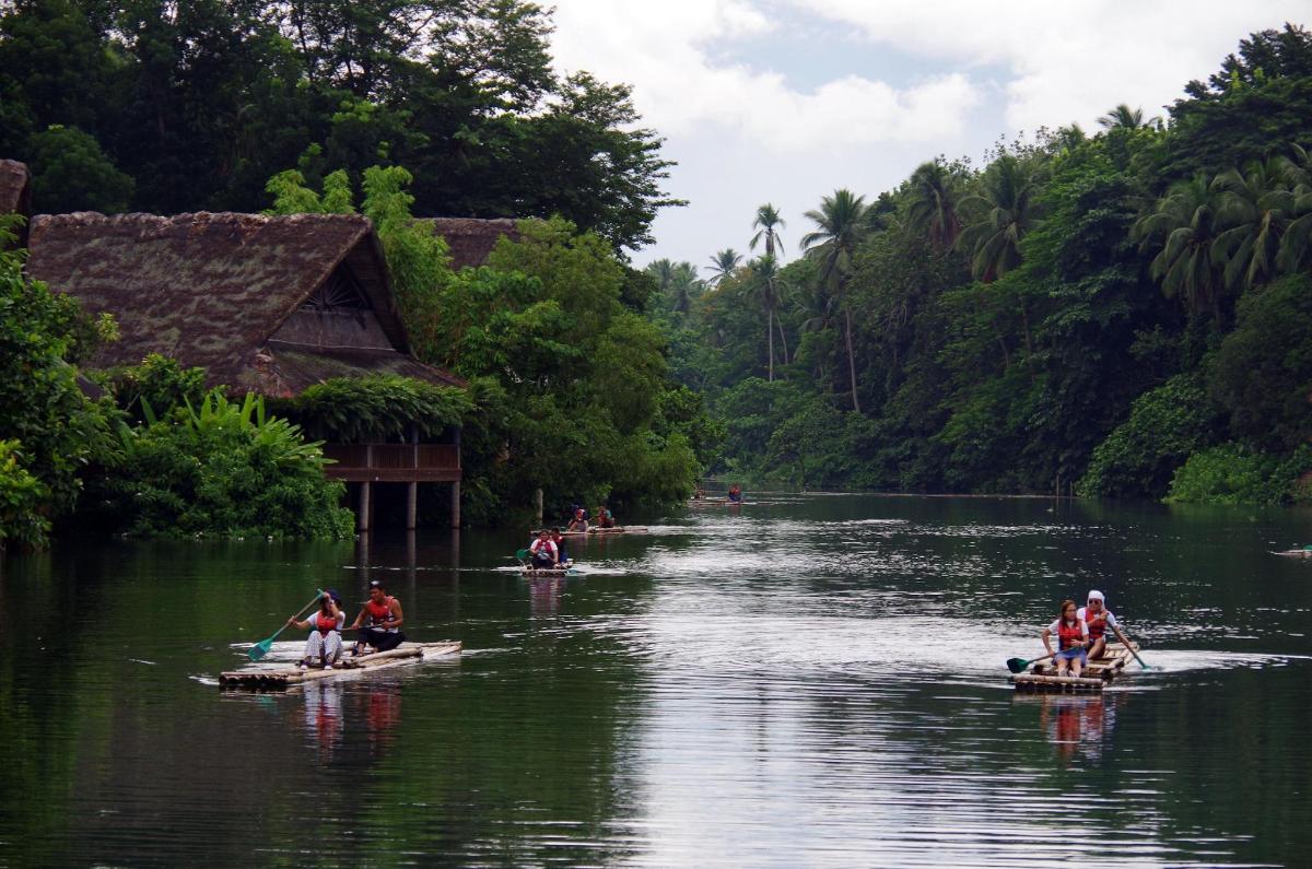 a group of people on boats in a river