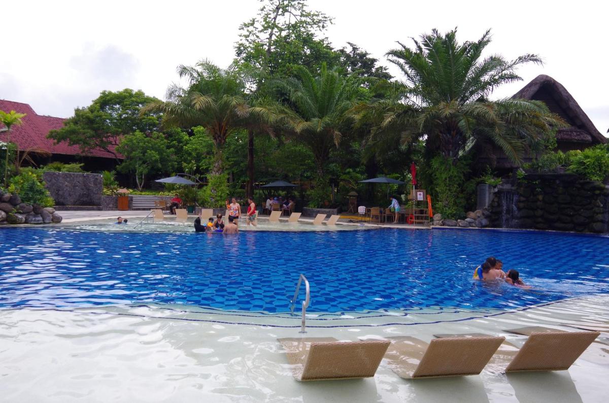 a swimming pool at a resort with people in it