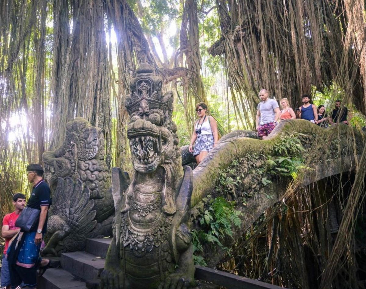 a group of people sitting on a statue in a tree