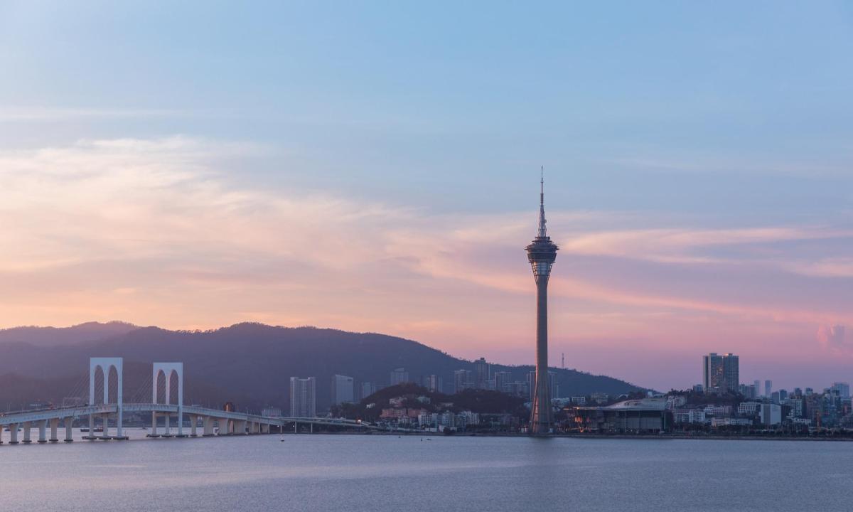 a view of a city with a tower and a bridge