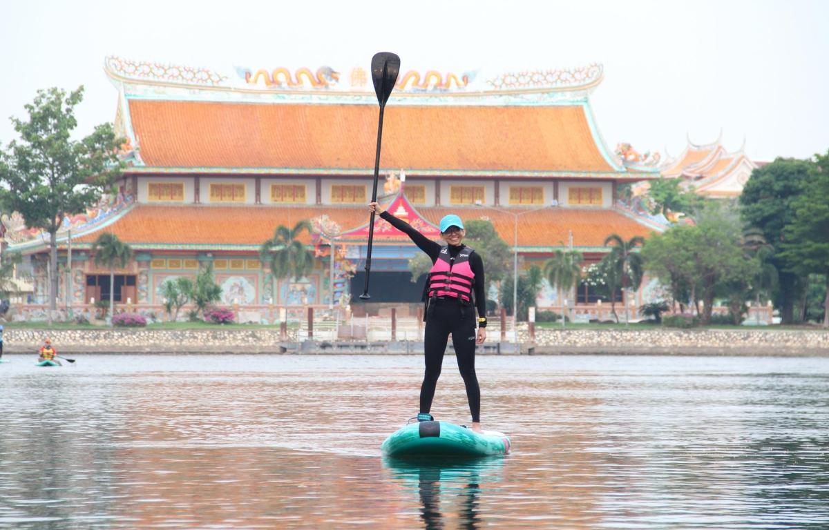a woman standing on a paddle board in the water