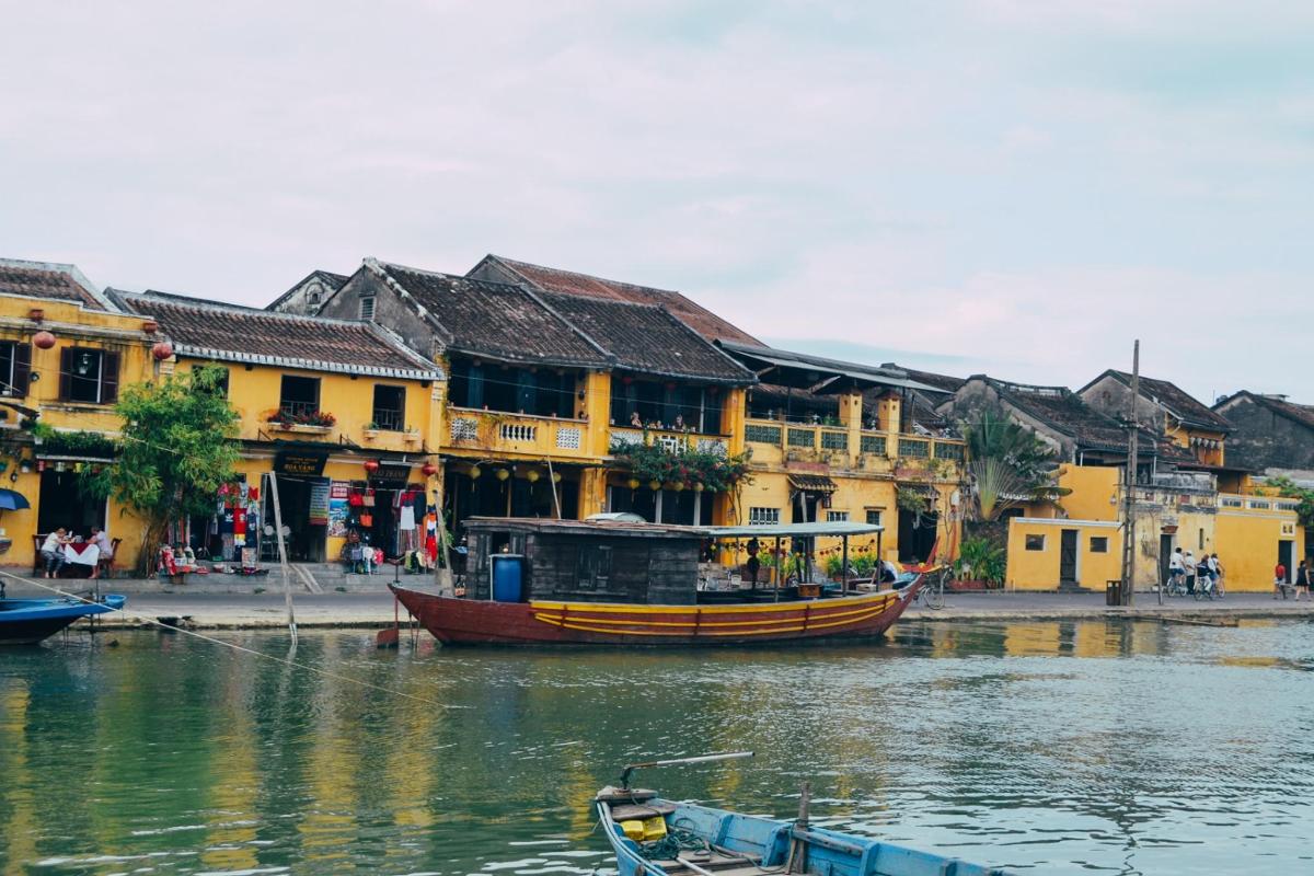 a boat on the water in front of buildings