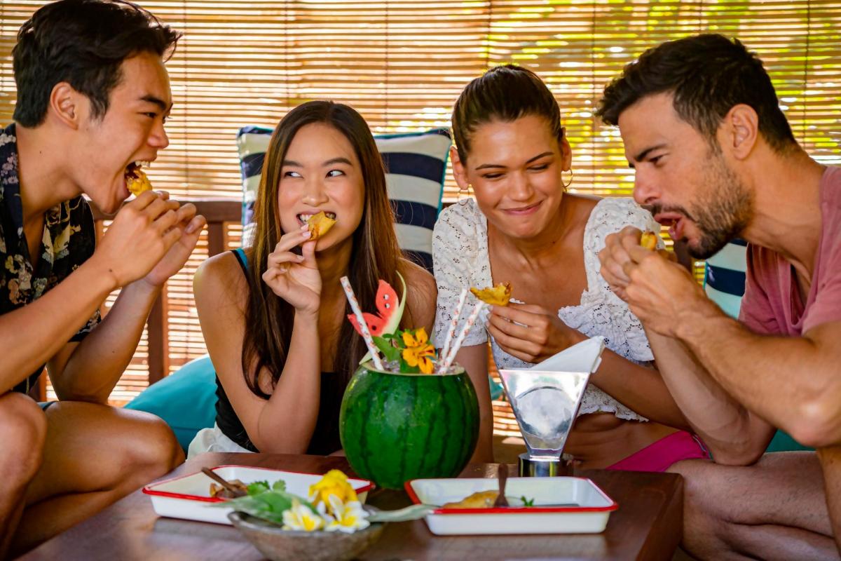 a group of people sitting around a table eating food
