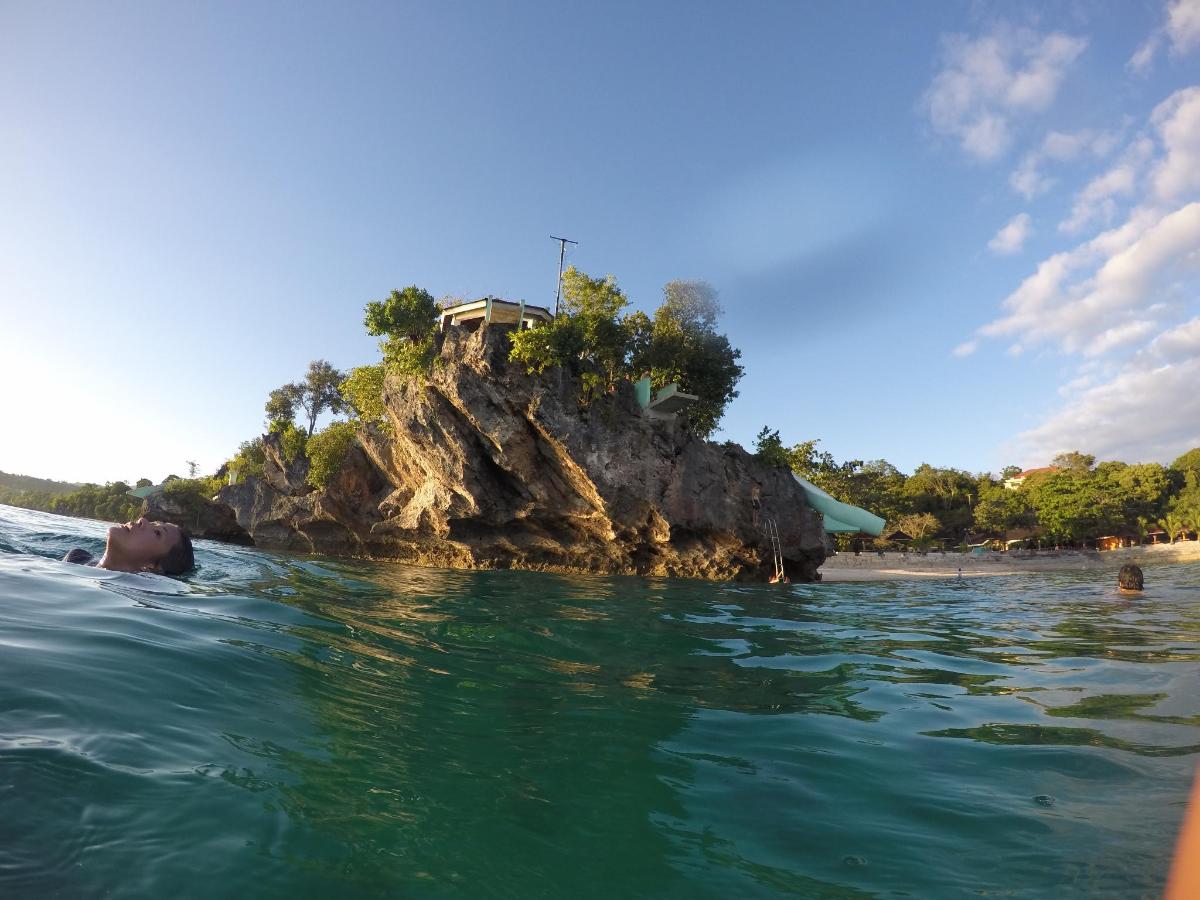 a person in the water in front of an island
