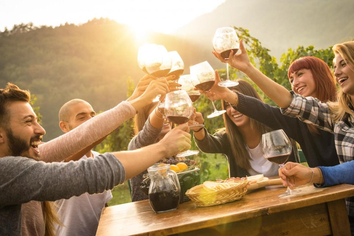 a group of people holding up glasses of wine