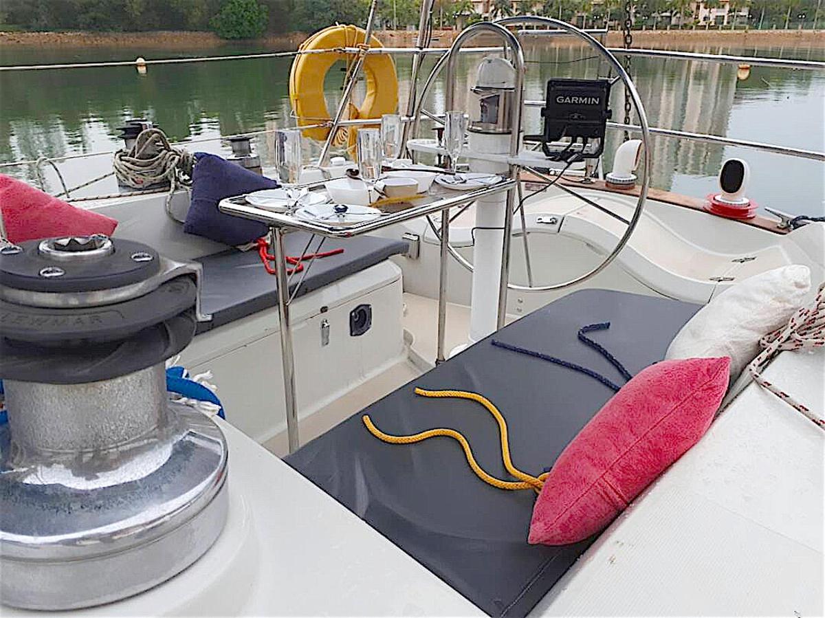 a boat with red pillows on the deck of it