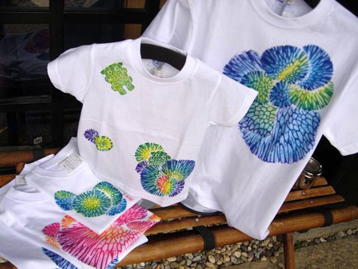 two shirts with hearts on them sitting on a bench