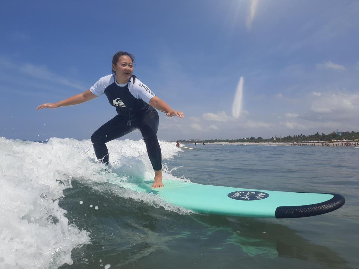 a woman riding a wave on a surfboard in the ocean