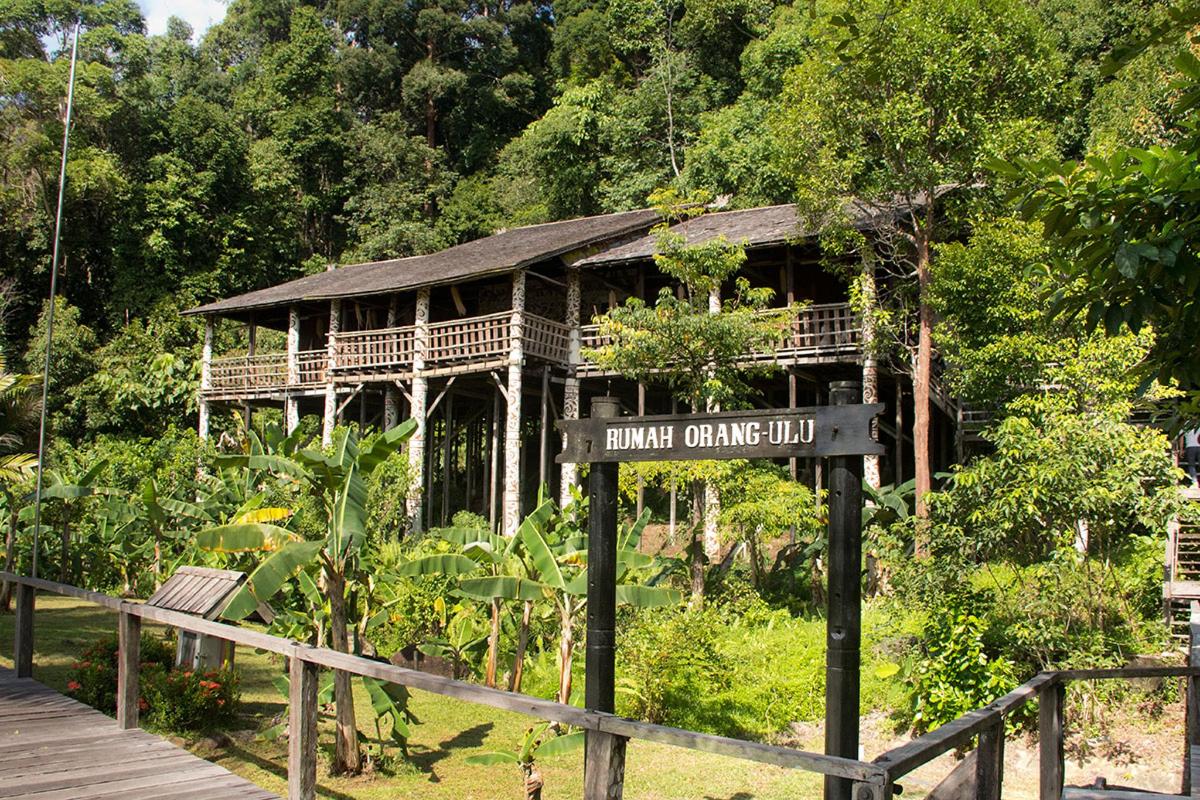 a wooden house with a sign in front of it