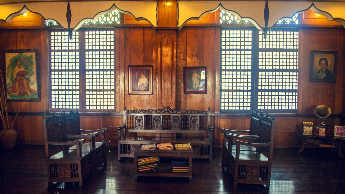 a room with windows and a table and chairs