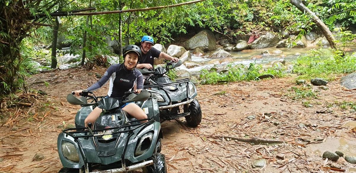 a couple of people riding on a four wheeler