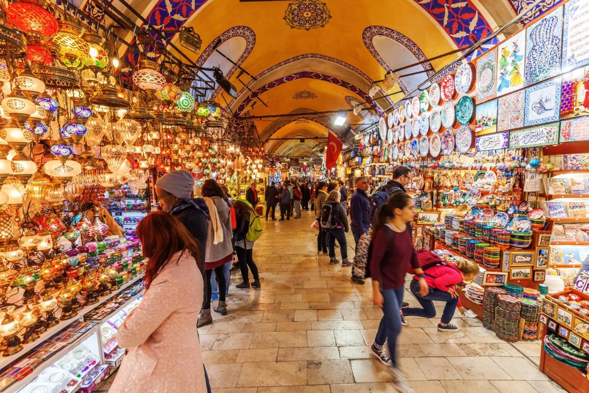 people walking through a market in the spice bazaar