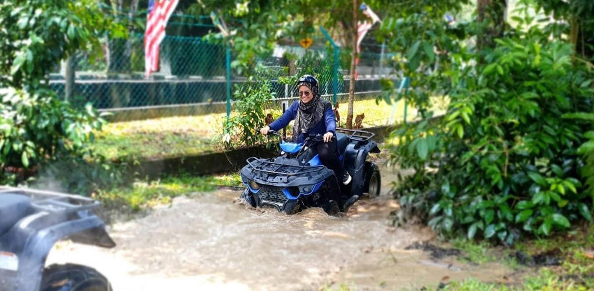 un uomo che guida un quad in acqua