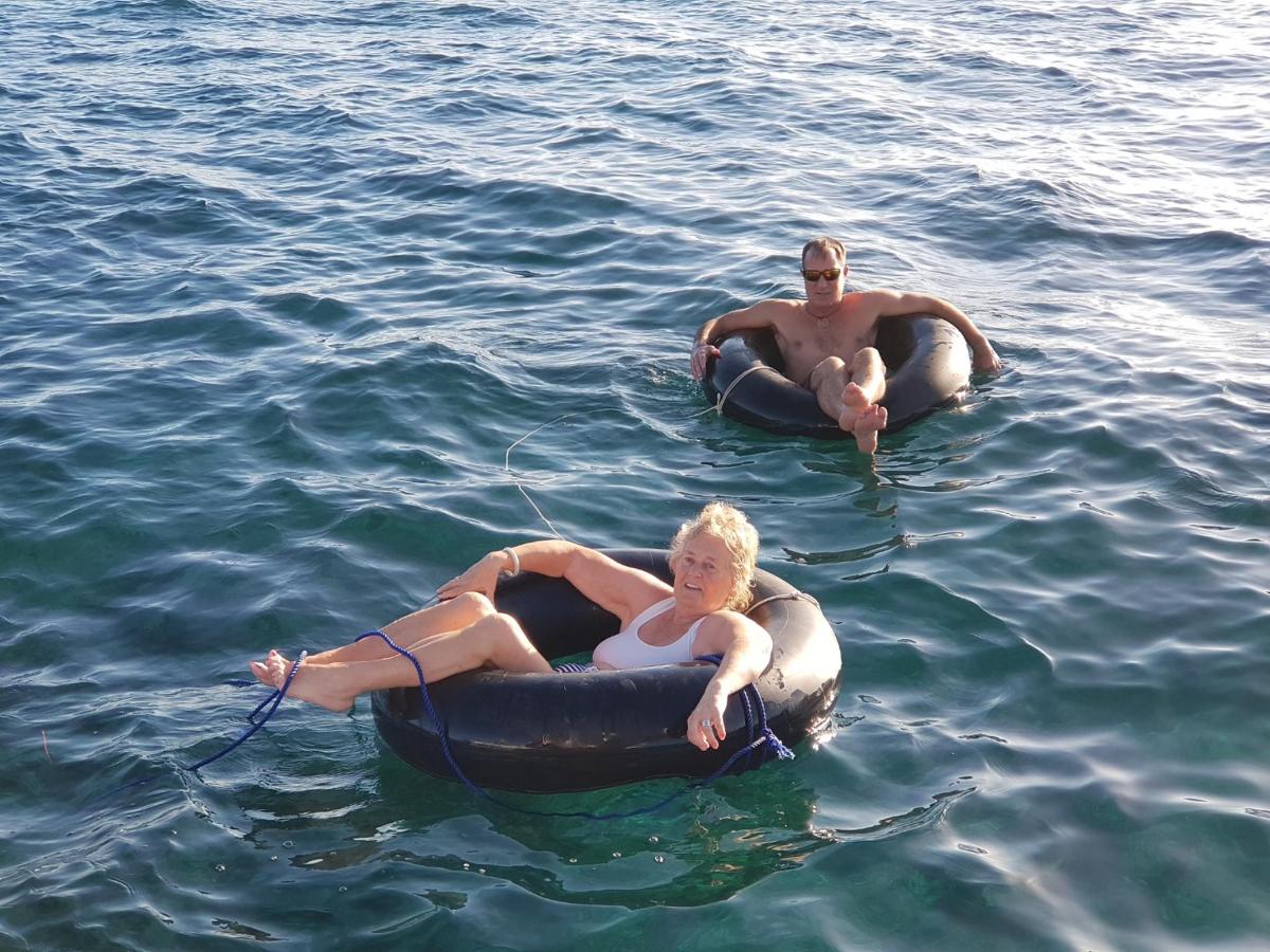a man and a woman in the water on tubes