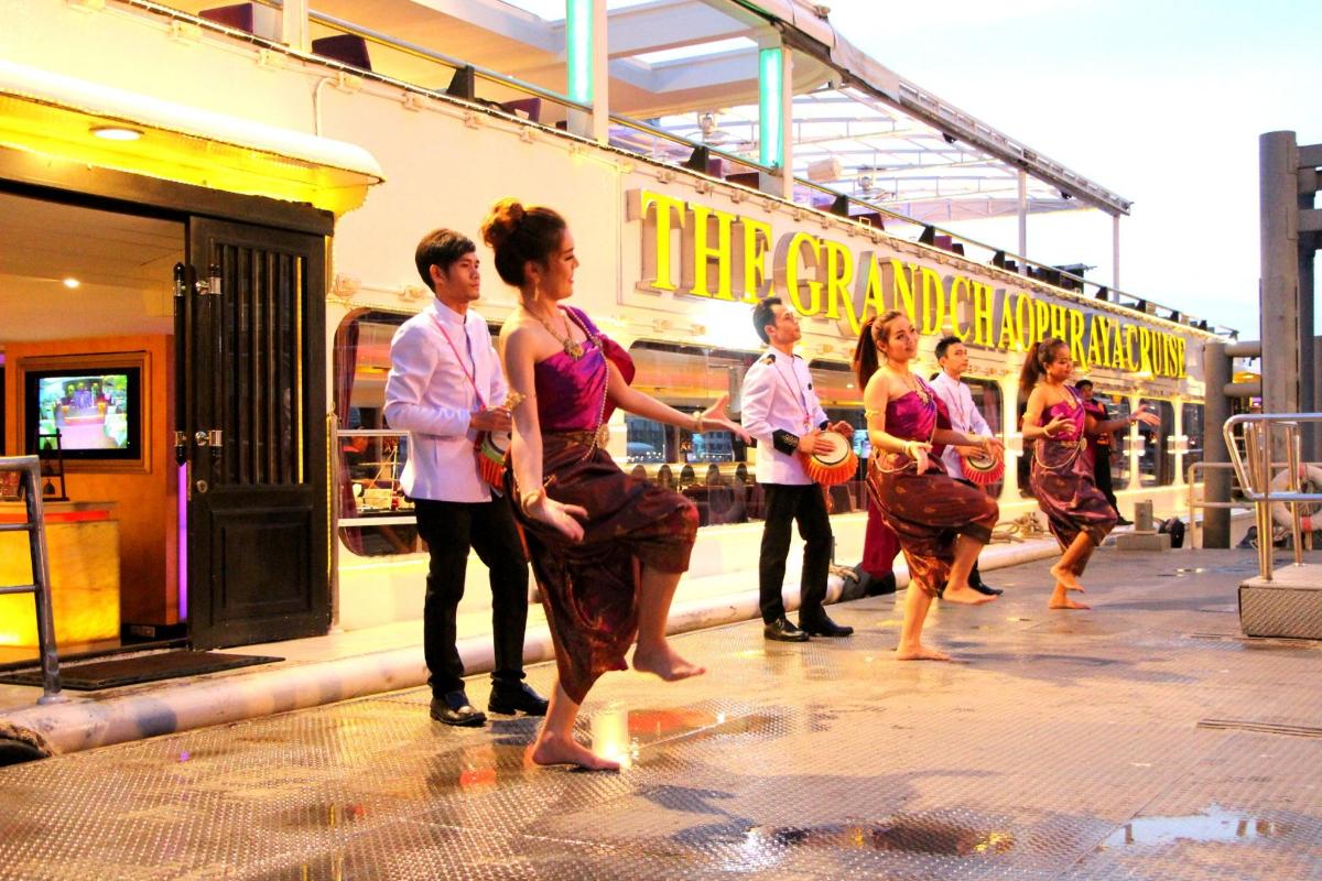 a group of people dancing in front of a train