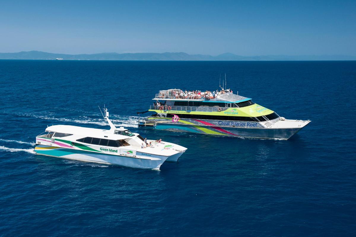 two boats in the water with people on them