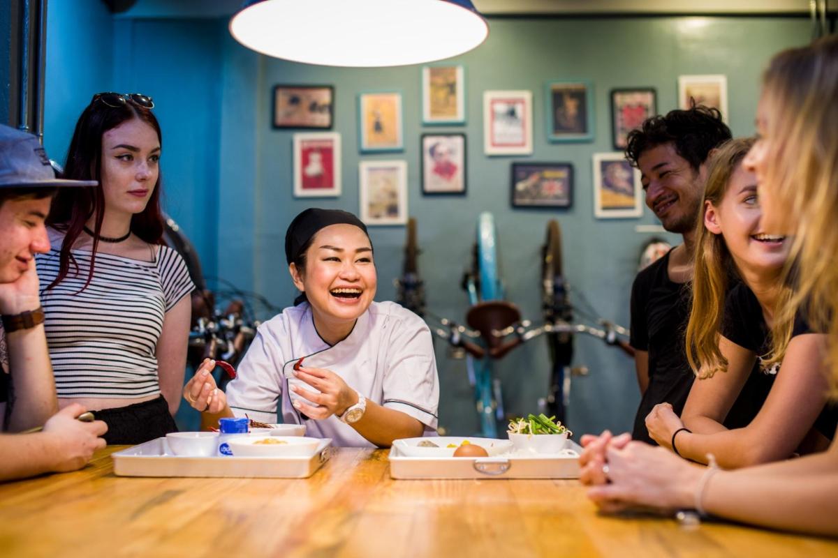 a group of people sitting around a table eating food