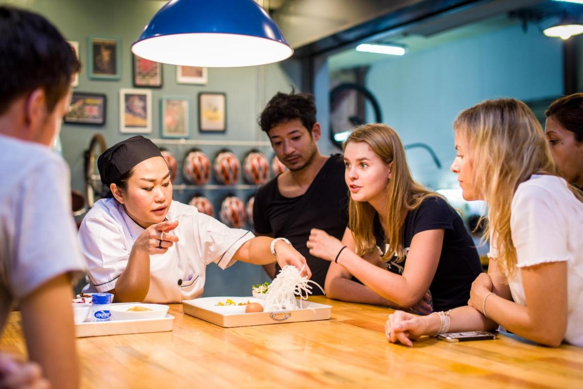 a group of people sitting around a table eating food