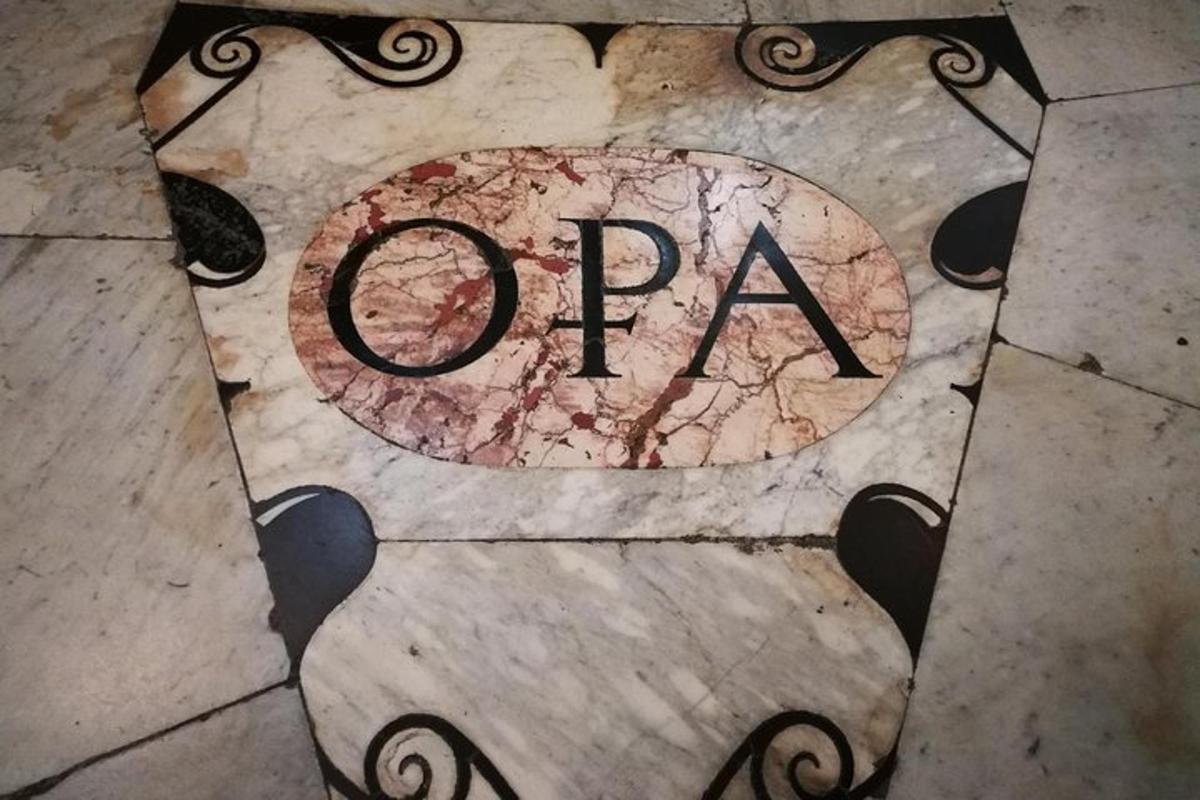 μια πινακίδα με τη λέξη ανοιχτό σε ένα πλακάκι δαπέδου