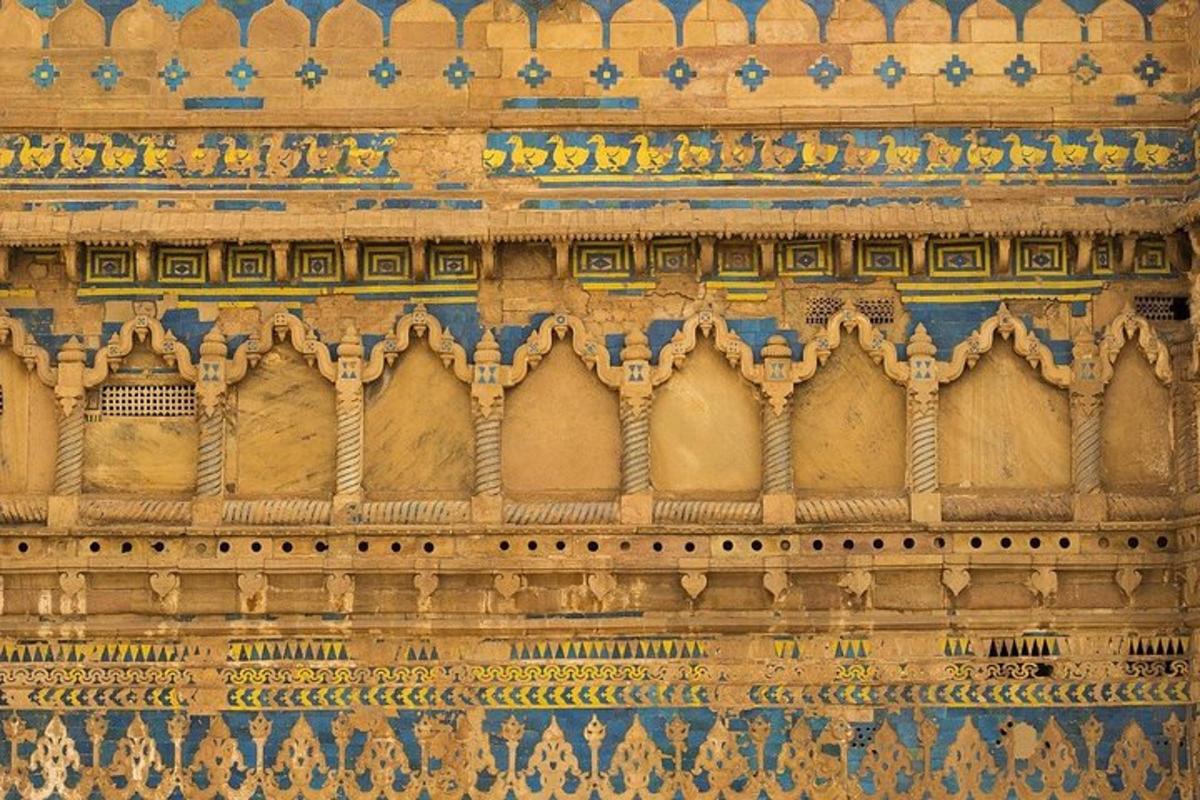 a stone wall with intricate designs on it