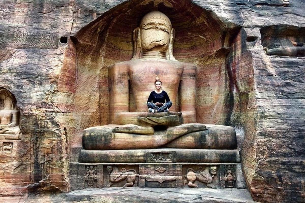 a man sitting on a large statue in a building