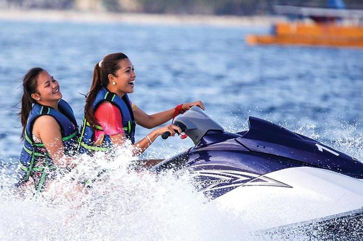 two women riding on a jet ski in the water