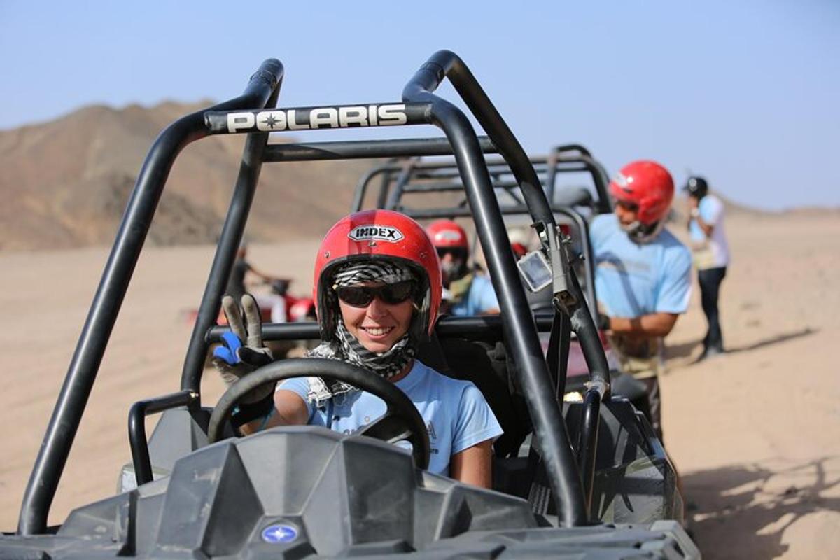 a man wearing a red helmet sitting in a golf cart