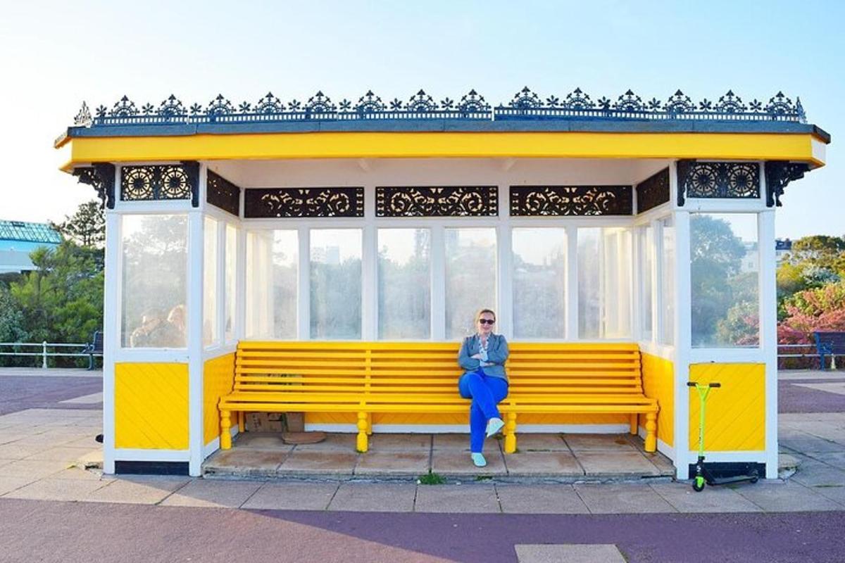 a woman sitting on a yellow bench in a pavilion