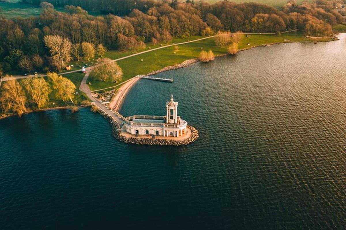 an island with a lighthouse in the middle of a lake