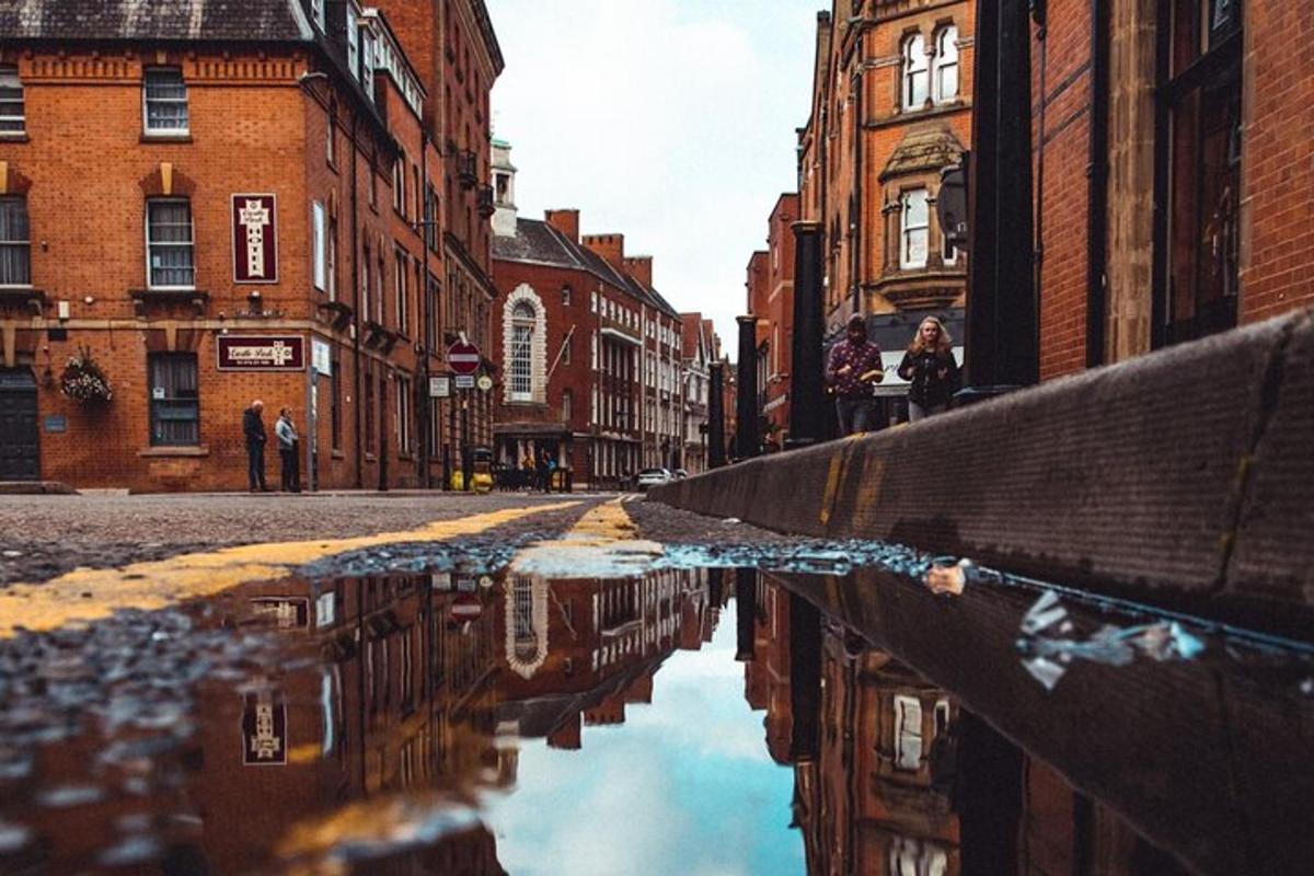 a city street with a puddle of water on the street