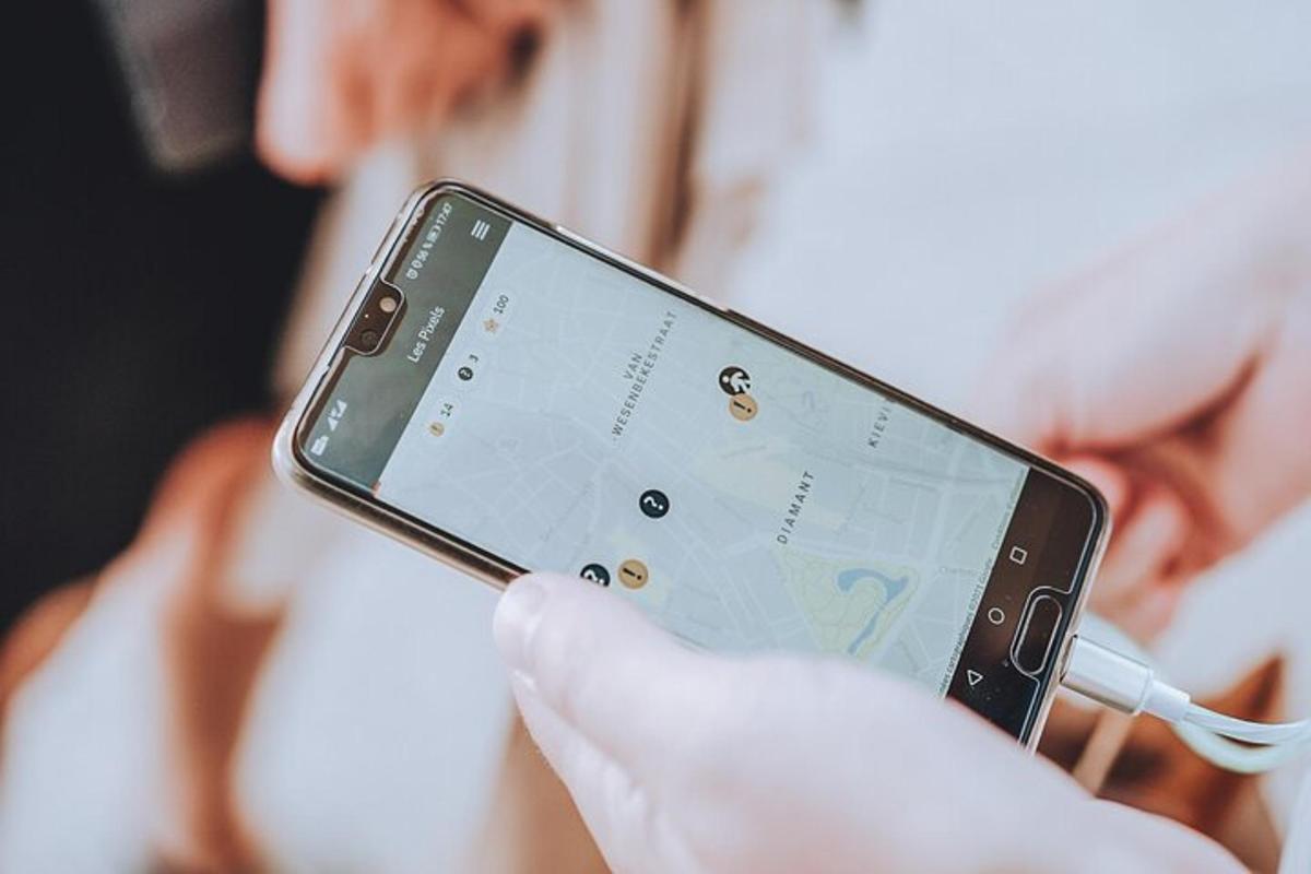 osoba držící v ruce mobilní telefon