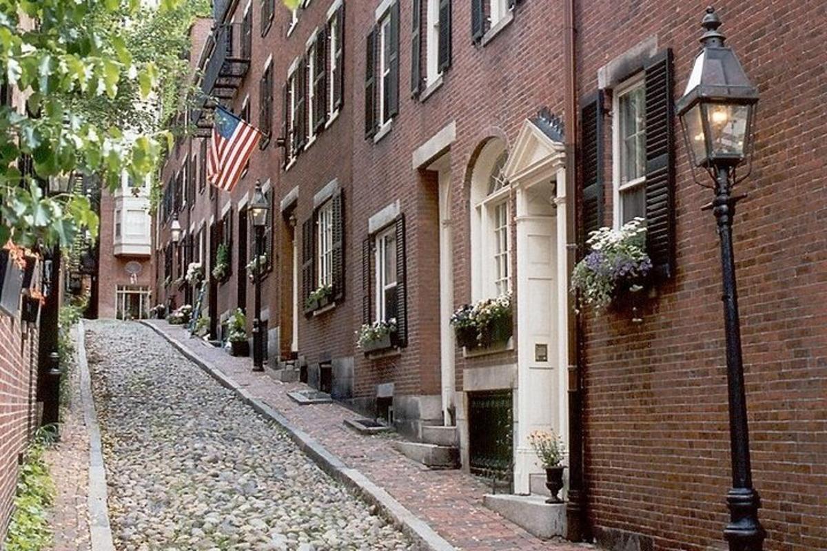 an empty street next to a brick building with a street light