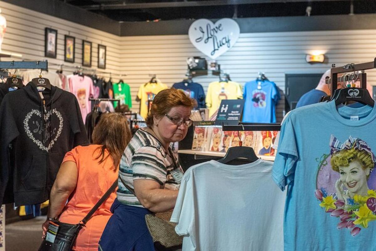 a woman standing in a store looking at clothes