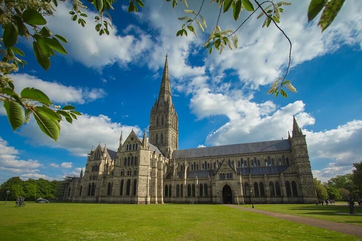 a large building with a tower and a grass field