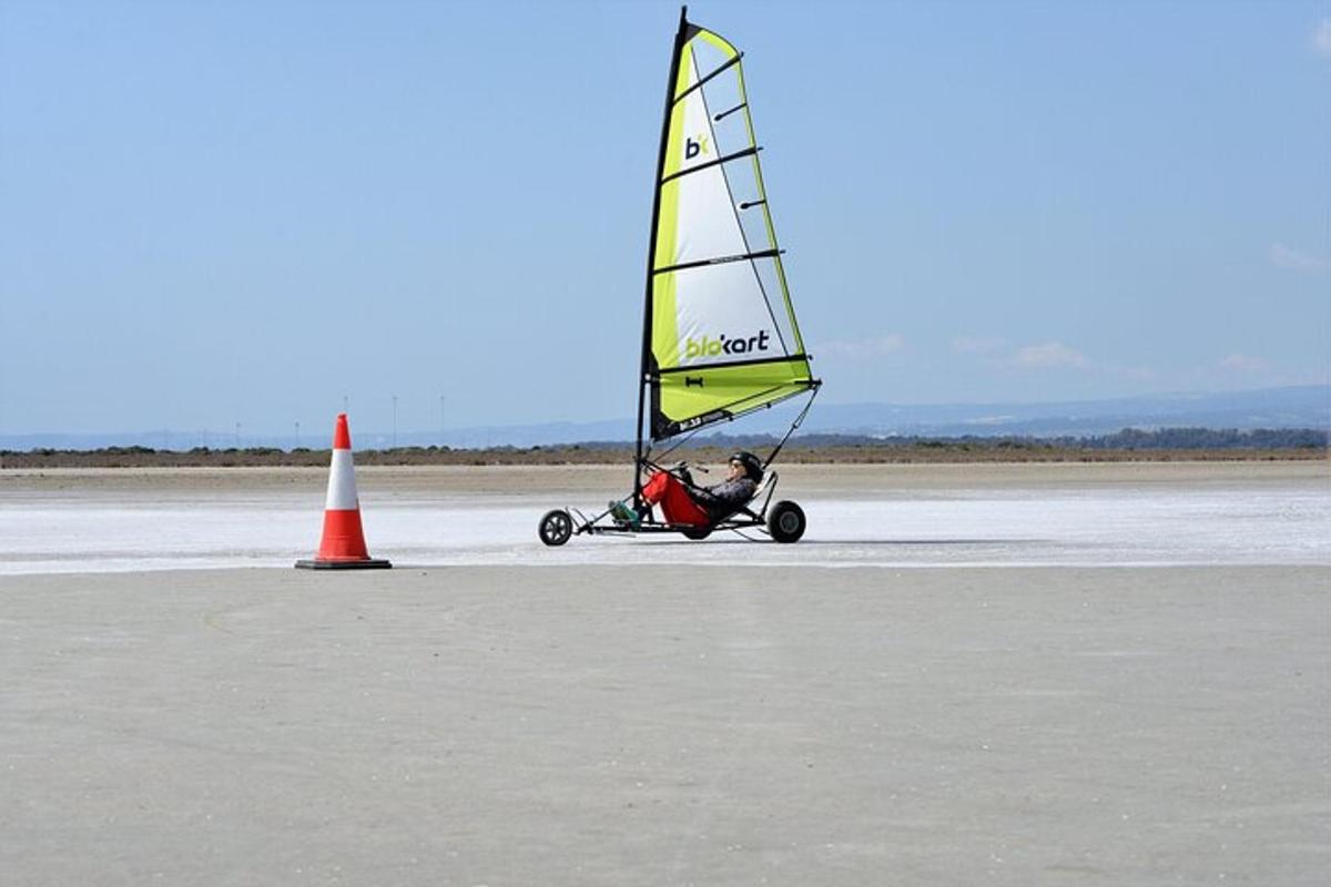 a person riding a small sail boat on a runway