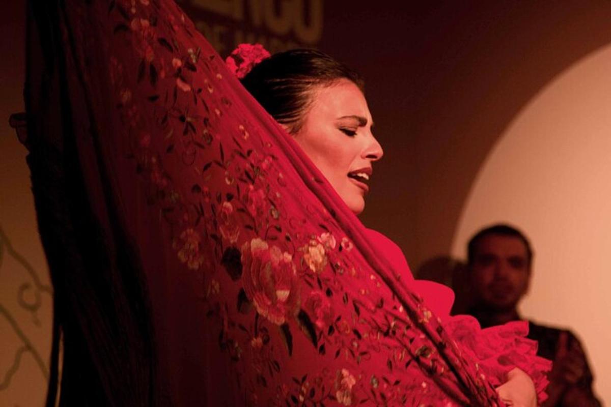 a woman is holding a red curtain