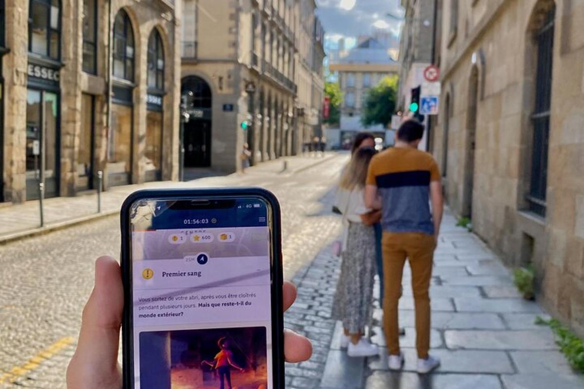en person, der holder en mobiltelefon op på gaden