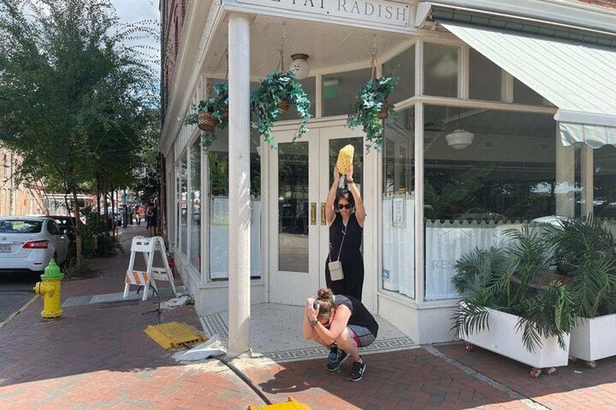 a woman taking a picture of a woman in front of a building
