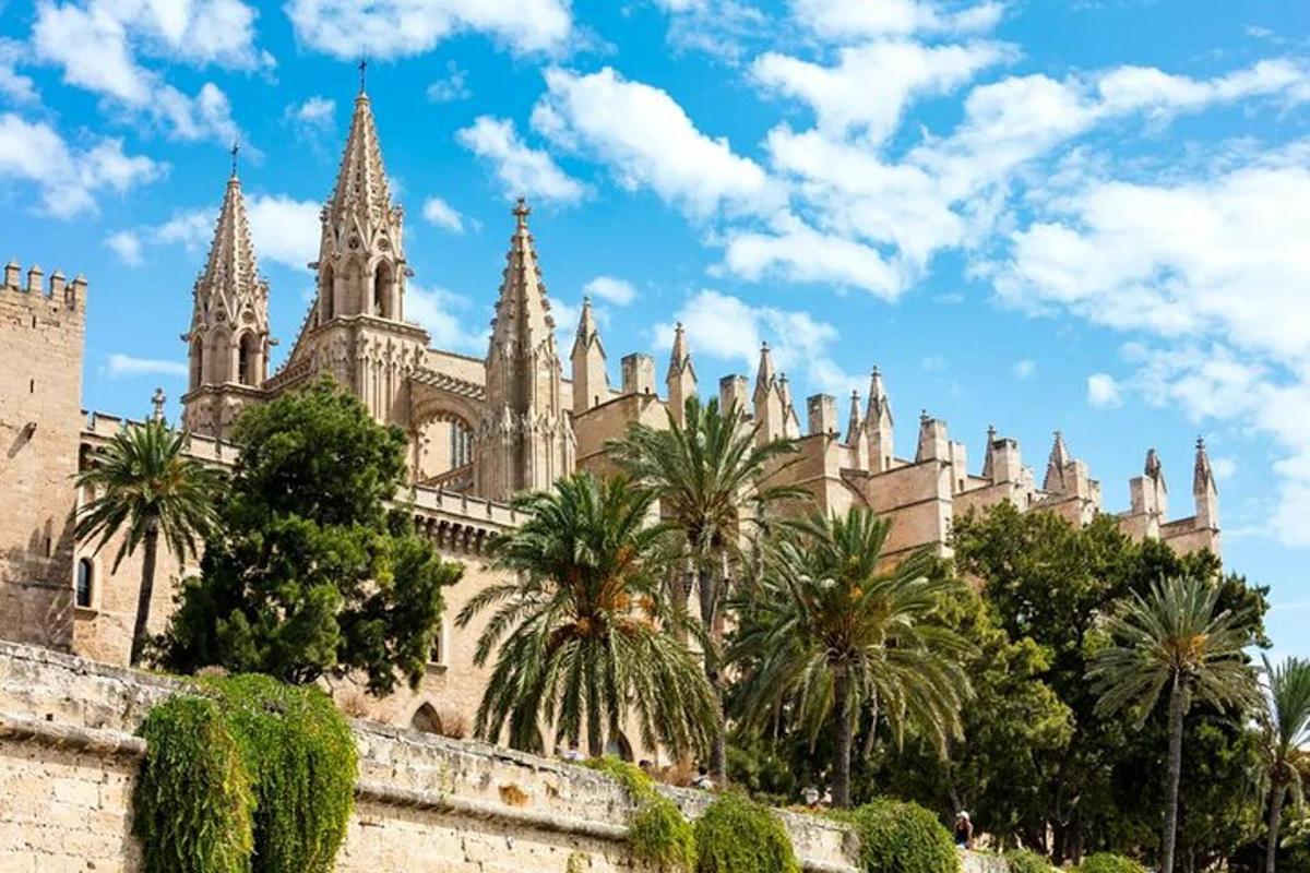 a building with towers and palm trees in front