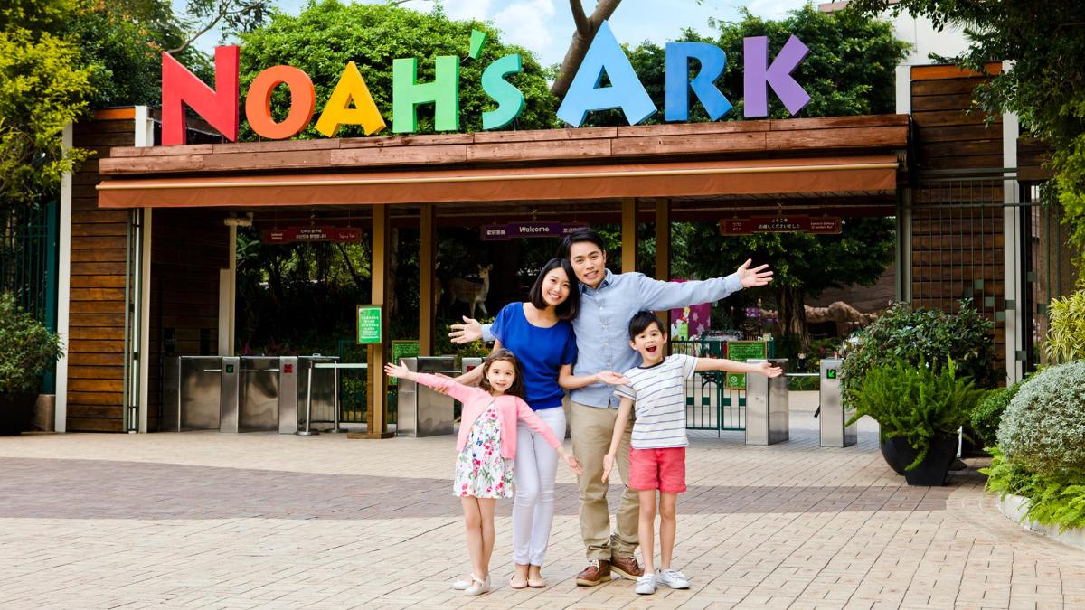 a family posing for a picture in front of a noahs ark
