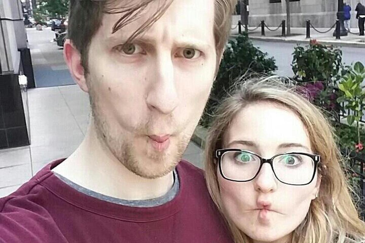 a man and a woman with glasses posing for a picture