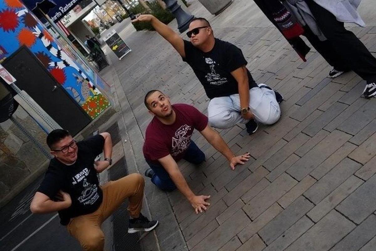 a group of three men sitting on the ground